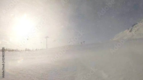 super slow motion: snow avalanche, skier spraying snow