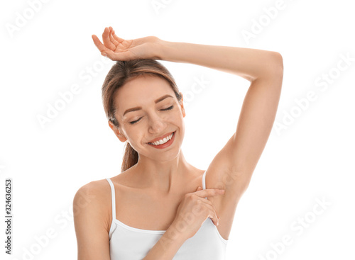 Young woman showing armpit with smooth clean skin on white background © New Africa