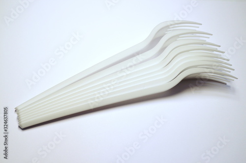 several plastic forks on a white background