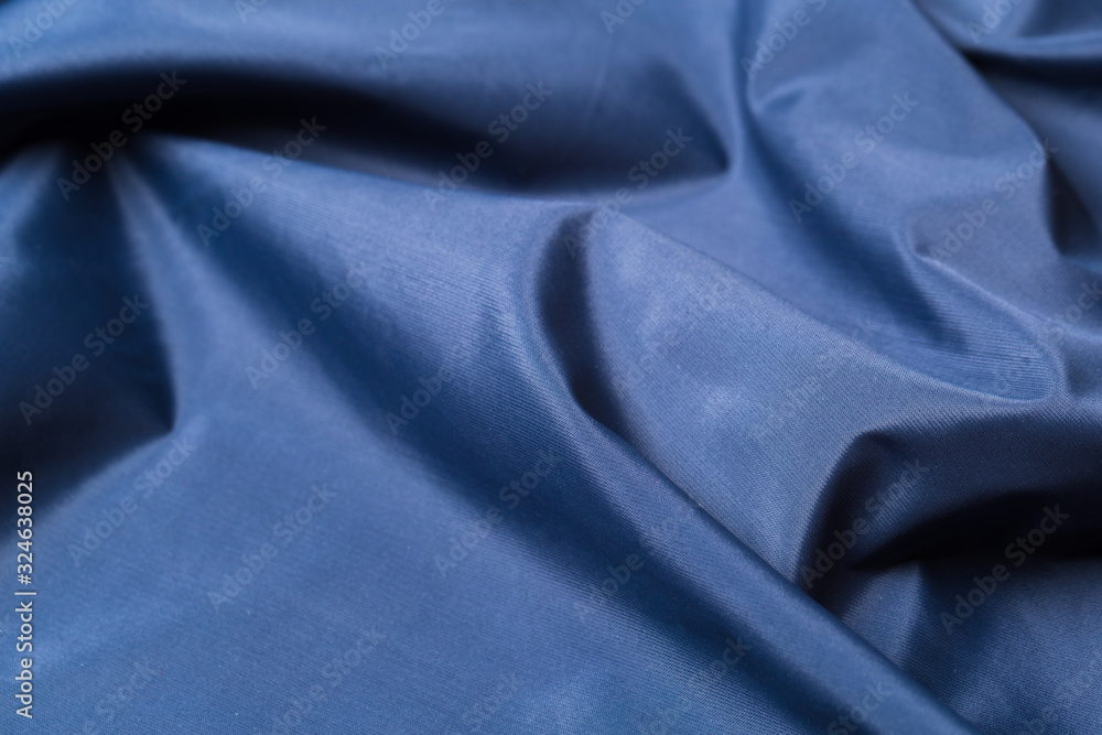Fototapeta premium Blue fabric cloth texture. abstract texture background with soft waves.