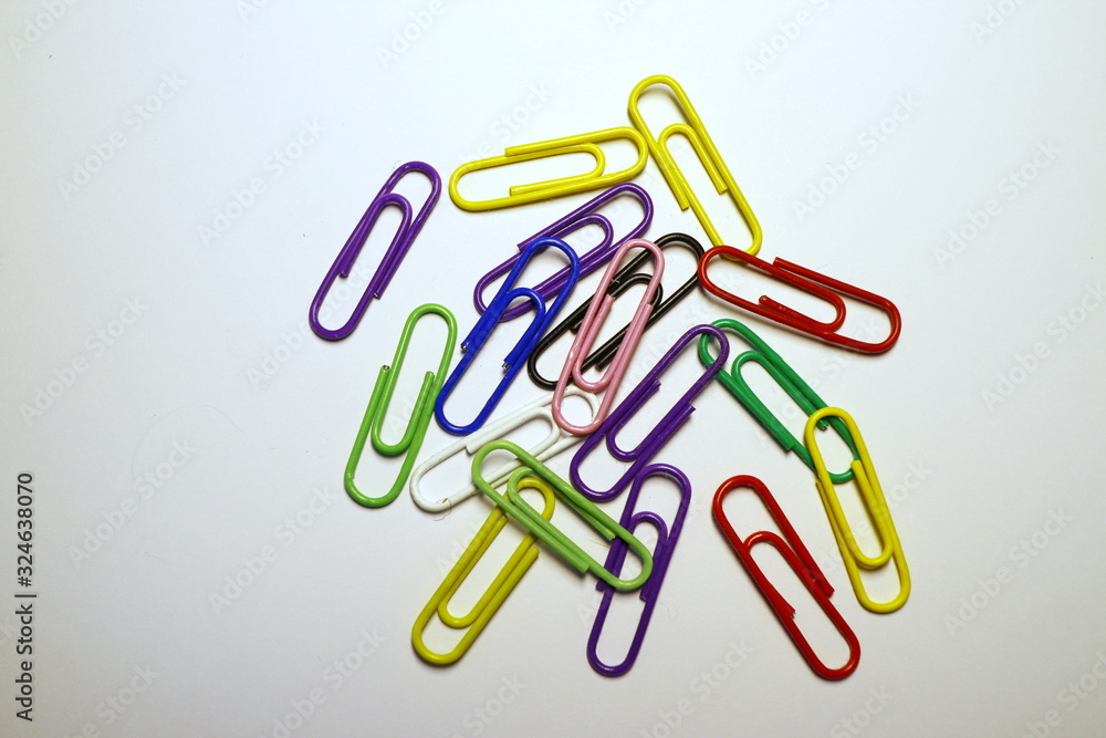 Multicolored paper clips on a white background Multicolored paper clips on a white background