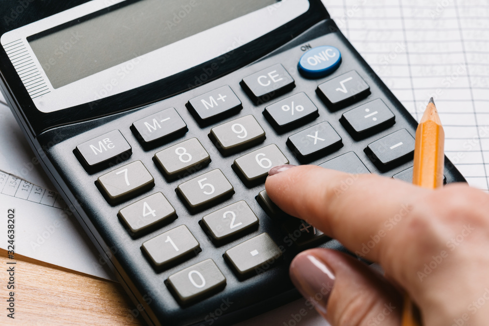 Accounting, financial concept, flat lay, calculator and pensil on wooden table Accounting, financial concept, flat lay, calculator and pensil on wooden table