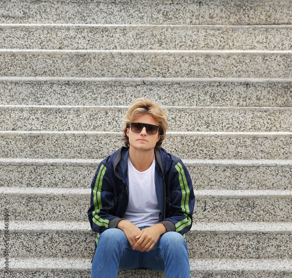 Attractive teenage boy in urban background. Attractive teenage boy in urban background.
