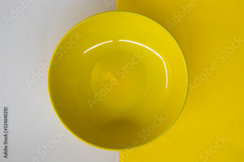 Empty yellow ceramic plate on white clear background, glossy bowl, weight loss diet, anorexia