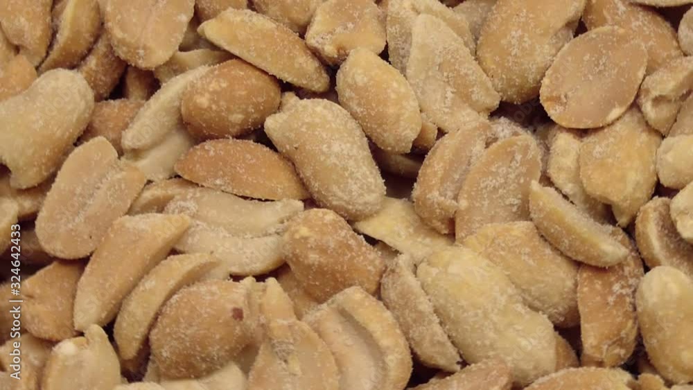 Fried salted peanuts rotates. View from above. Fried salted peanuts rotates. View from above.