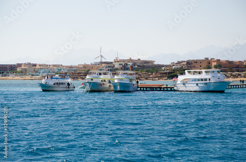 Yacht and motor boat at the pier. The shore of the Red Sea.