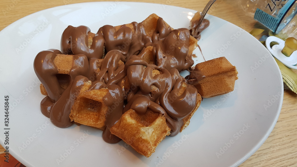waffle chocolated hot liquid on the plate waffle chocolated hot liquid on the plate