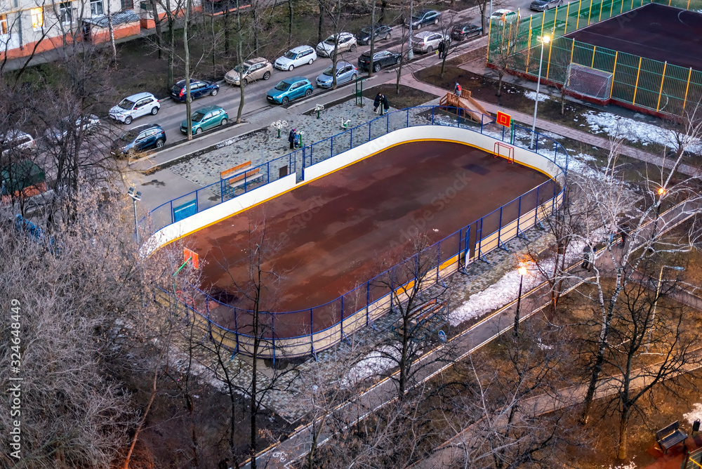 Sports ground in the yard of residential district at dusk in winter Sports ground in the yard of residential district at dusk in winter