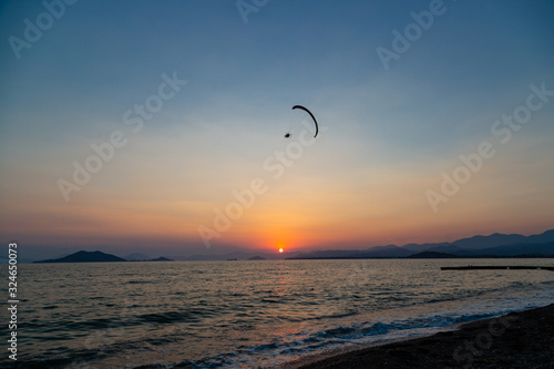 paraglider over the beach during Sunset on the Calis Beach on the Aegean Sea © sedan504