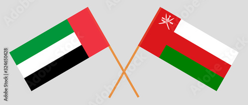 Crossed flags of Oman and the United Arab Emirates