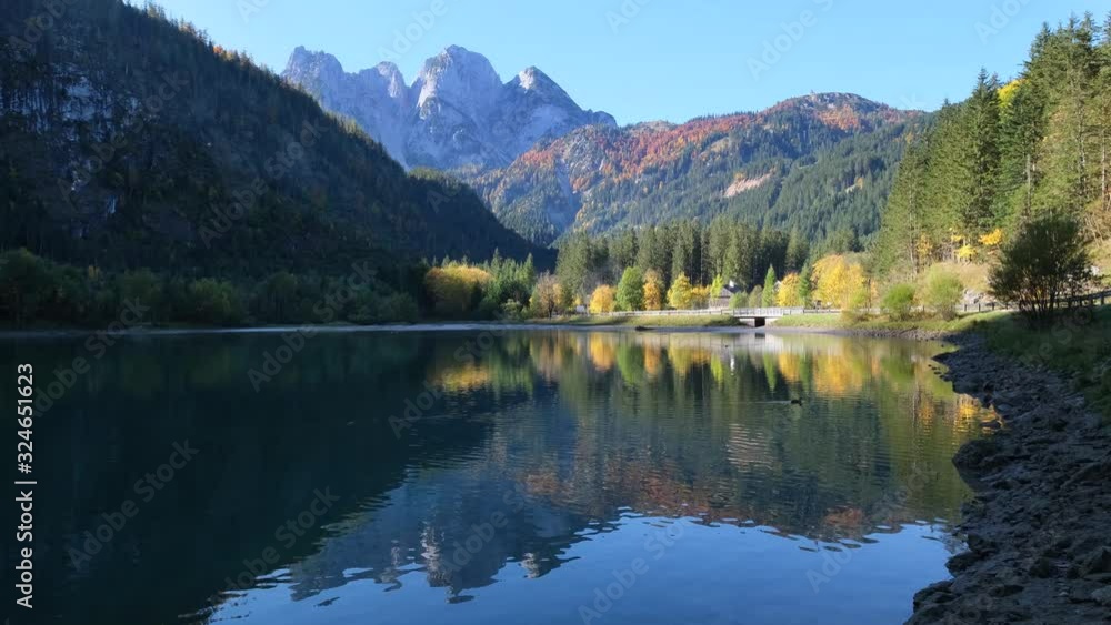 Peaceful autumn Alps mountain lake. Gosauseen or Vorderer Gosausee lake, Upper Austria. Dachstein summit and glacier in far. Peaceful autumn Alps mountain lake. Gosauseen or Vorderer Gosausee lake, Upper Austria. Dachstein summit and glacier in far.