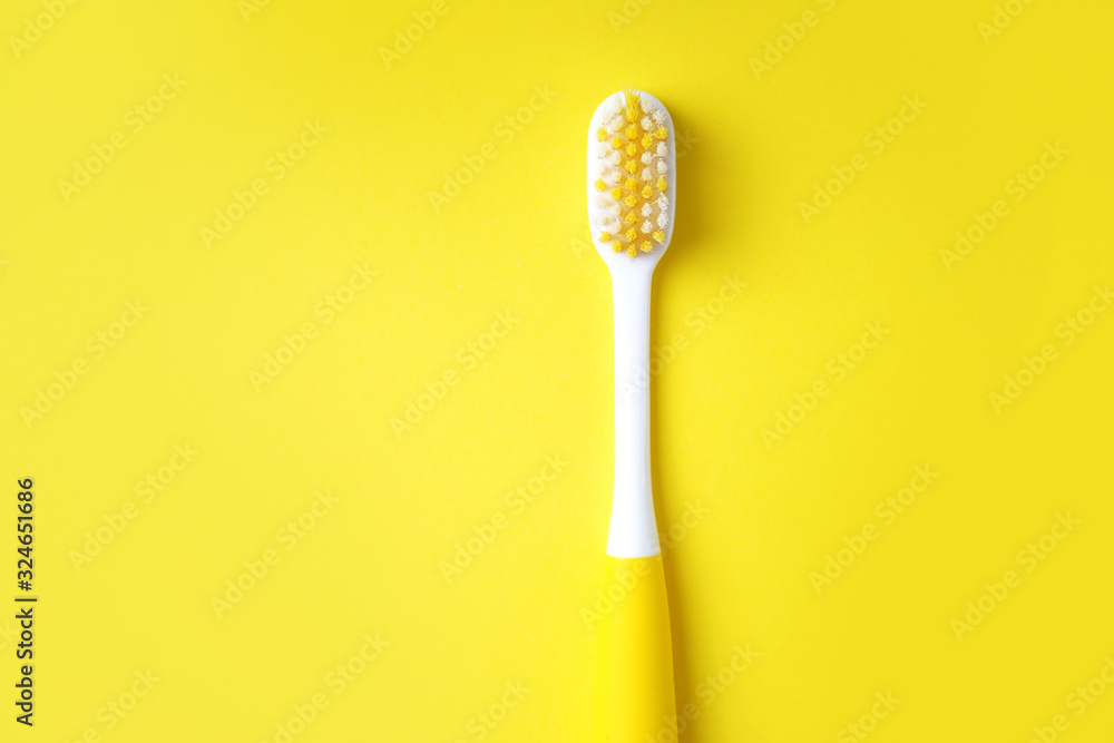 Toothbrush on a yellow background. Dental concept. Minimal composition with a copy space. Toothbrush on a yellow background. Dental concept. Minimal composition with a copy space.