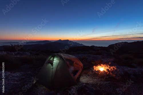 Camping in the mountains with campfire