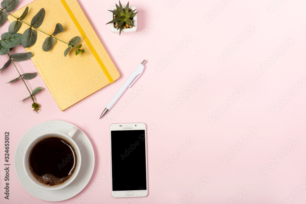 office pink table, white cup with coffee and phone, notebook and pen on a pink background, minimalism concept, place for text office pink table, white cup with coffee and phone, notebook and pen on a pink background, minimalism concept, place for text