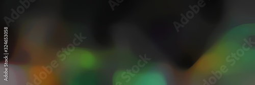 blurred iridescent landscape format background with very dark green, dark olive green and brown colors and space for text or image