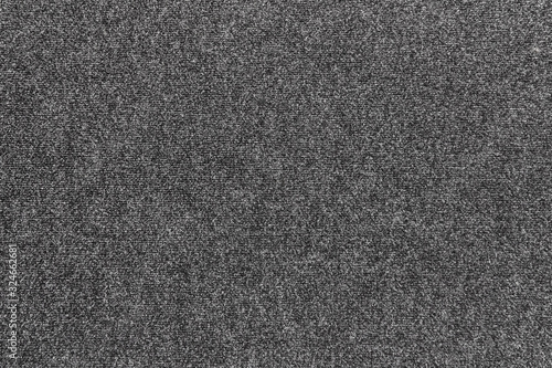 The texture of the gray carpet with a short pile.