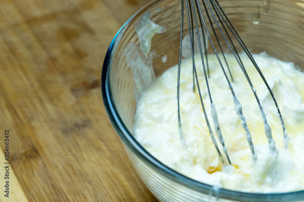 Mixing ingredients to prepare a complex dish.