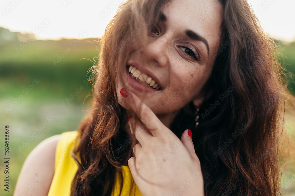 Curly girl in a yellow dress at sunset. Curly girl in a yellow dress at sunset.