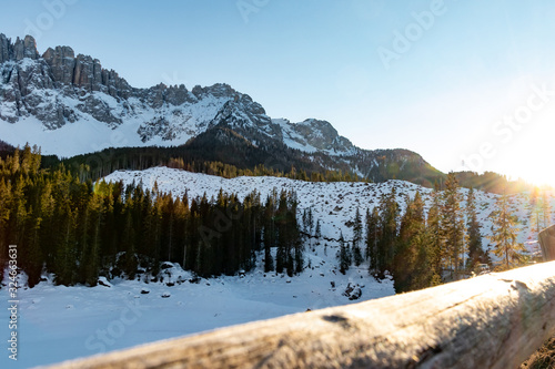 The famous mountains latemar in south tyrol, italy, with the frozen lake karersee in the front