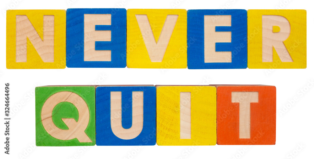 Inspirational NEVER QUIT concept spelled out in colorful toy alphabet  blocks.
