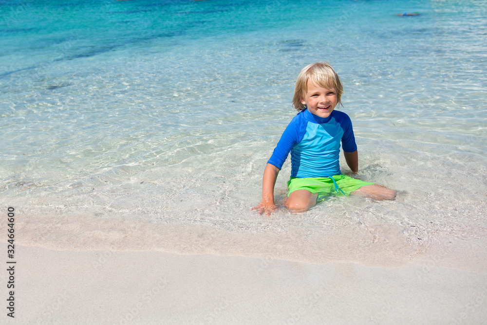 Happy little boy on the beach during summer vacations Happy little boy on the beach during summer vacations