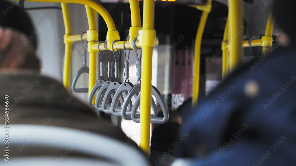 Close up. people inside public transport bus. Handrails to hold Close up. people inside public transport bus. Handrails to hold