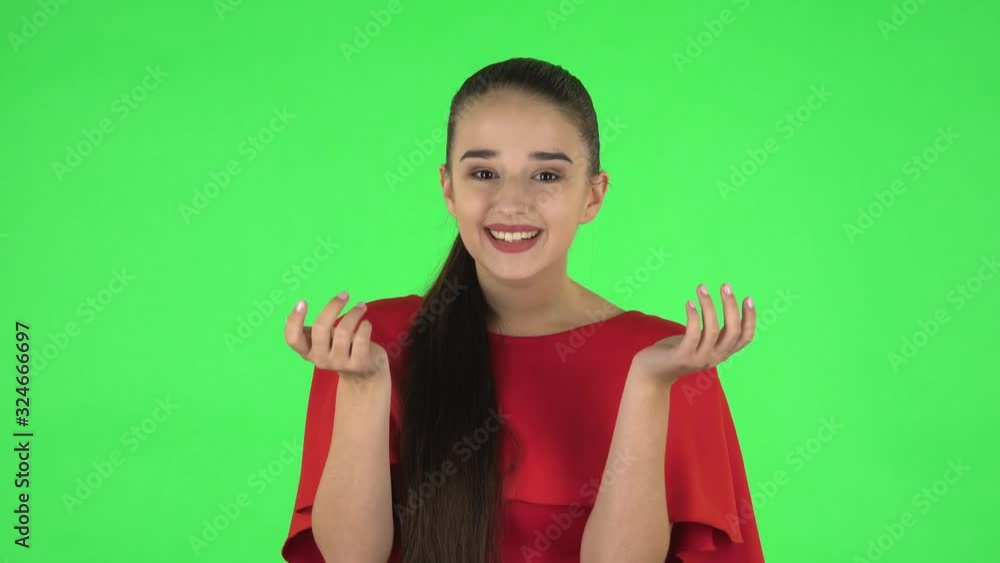 Portrait of pretty young woman is smiling and showing blowing kisses. Green screen Portrait of pretty young woman is smiling and showing blowing kisses. Green screen