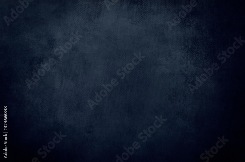dark blue grunge background or texture with black vignette borders