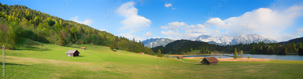 wide landscape panorama lake gerold and pasture with huts, view to karwendel mountains