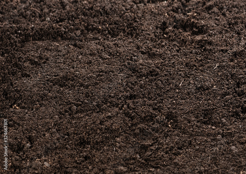 Top view of seamless dark soil texture background