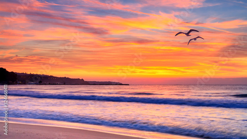 Seaside landscape - the beach with views of the sunrise over the sea, near the city of Varna, on the Black Sea coast of Bulgaria