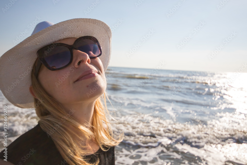 portrait of smiling woman at the beach with sunglasses portrait of smiling woman at the beach with sunglasses