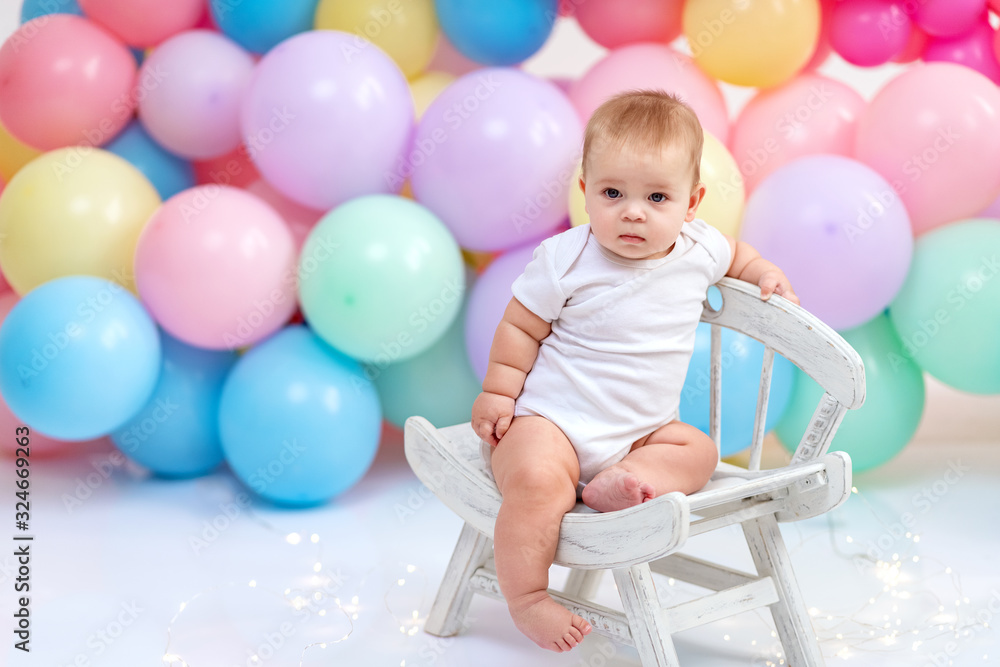 Сute baby boy on the background of balloons Сute baby boy on the background of balloons