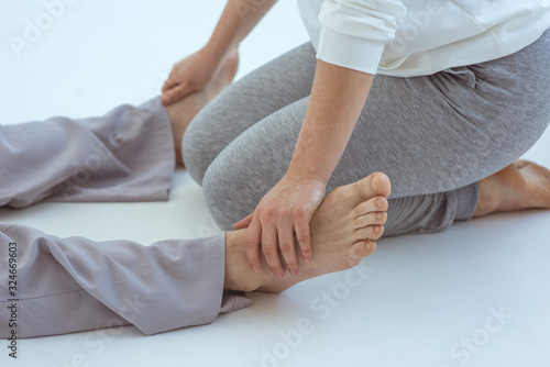 Hands (woman) making thai feet massage to a man. Alternative medicine and thai massage concept 