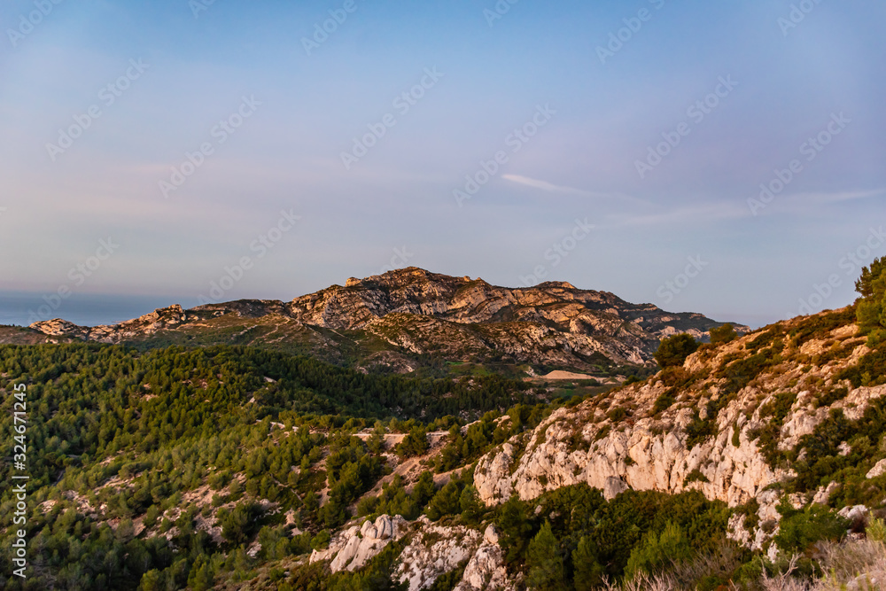 Sunrise at Calanque de Morgiou (Marseille, France): the breathtaking cliff mountain landscape under the warm soft sunlight Sunrise at Calanque de Morgiou (Marseille, France): the breathtaking cliff mountain landscape under the warm soft sunlight
