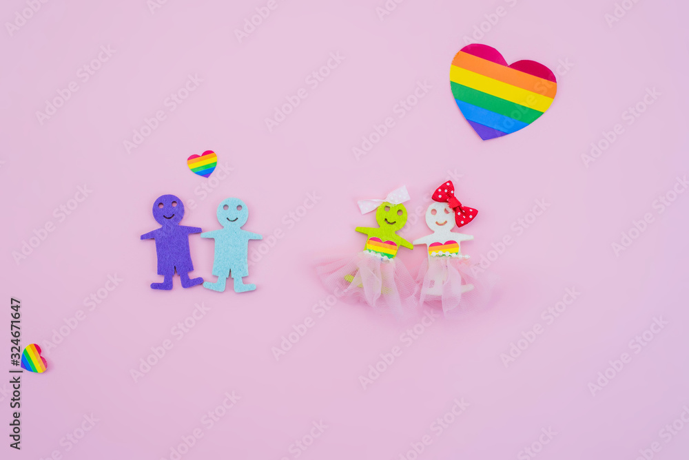 LGBT figures of people. Two figures of women and two figures of men show unconventional orientation. Marriage and family, couple. Rights of homosexual. Pink background.