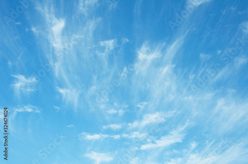   Bright blue sky background with tiny clouds. Sunny day