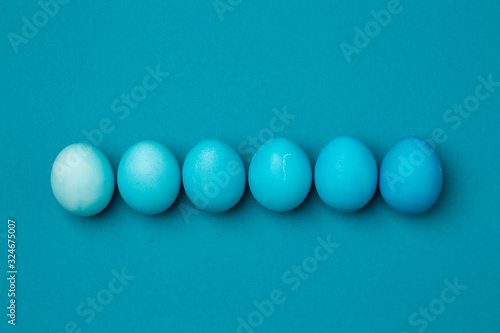 Six easter eggs in blue gradient color design on a blue background