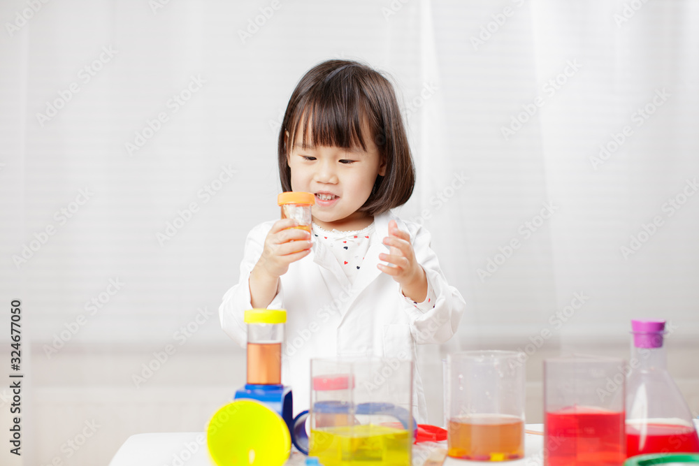 toddler girl pretend play scientist role at home against white background toddler girl pretend play scientist role at home against white background