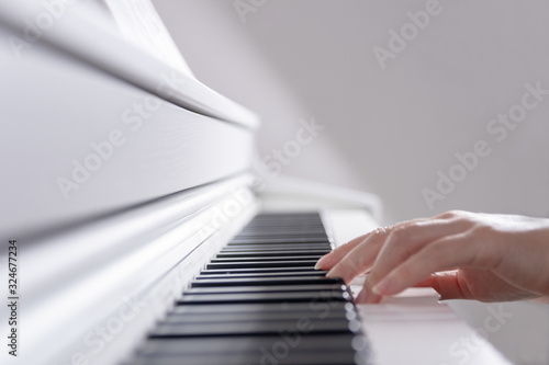 Stylish photo, female hands play the piano
