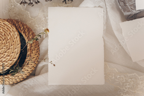 Wedding invitation mockup with dry plants , papers on white textile background. Top view, flat lay. Wedding stationary. Perfect for presentation of your invitation, menu, greeting cards © Georgiy