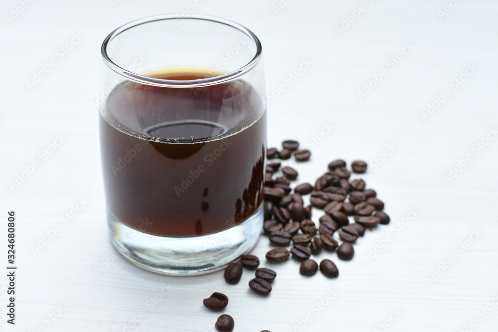 Glass of iced coffee, with Colombian coffee with coffee beans on wooden background Glass of iced coffee, with Colombian coffee with coffee beans on wooden background