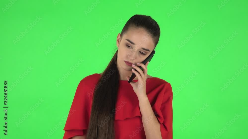Portrait of pretty young woman is talking for mobile phone. Green screen Portrait of pretty young woman is talking for mobile phone. Green screen