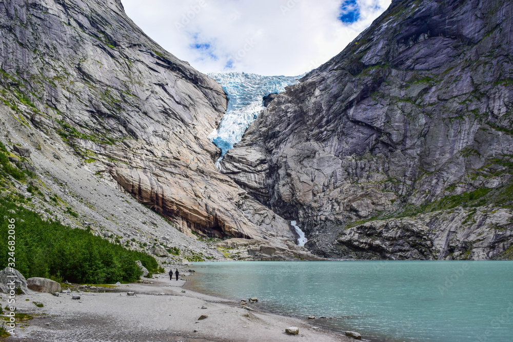 The Briksdalsbreen (Briksdal) glacier, which is the sleeve of the large Jostedalsbreen glacier in Norway. The melting glacier forms the Briksdalsbrevatnet lake with clear water.