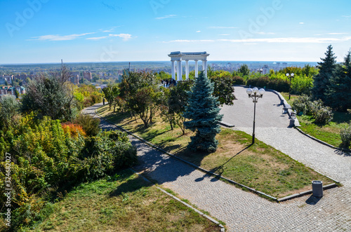 Beautiful and elegant White arbor or rotunda frendship in a park in Poltava, Ukraine photo