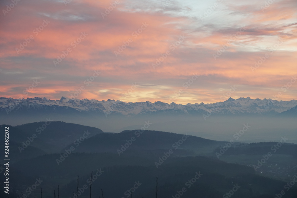 Evening panorama of Alps and hills in winter in Switzerland, Uetliberg canton Zurich.