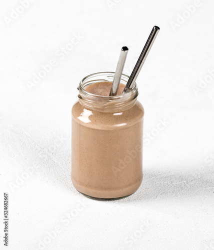Milk chocolate cocktail with ice cream in a jar on a light background