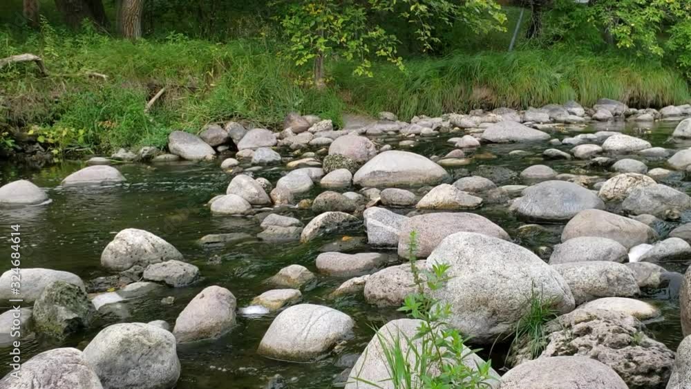 shot of water flowing through Sturgeon Creek in September in Winnipeg, Manitoba. shot of water flowing through Sturgeon Creek in September in Winnipeg, Manitoba.