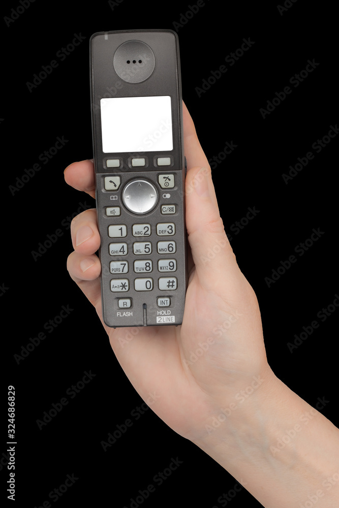 Female hand holds a phone with a white blank screen, isolated on black background Female hand holds a phone with a white blank screen, isolated on black background