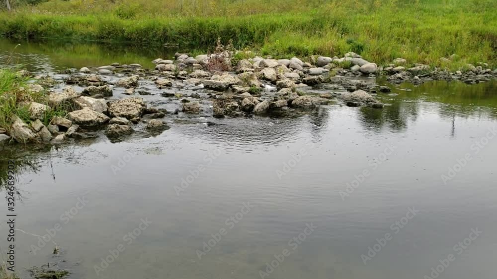 shot of water flowing through Sturgeon Creek in September in Winnipeg, Manitoba. shot of water flowing through Sturgeon Creek in September in Winnipeg, Manitoba.